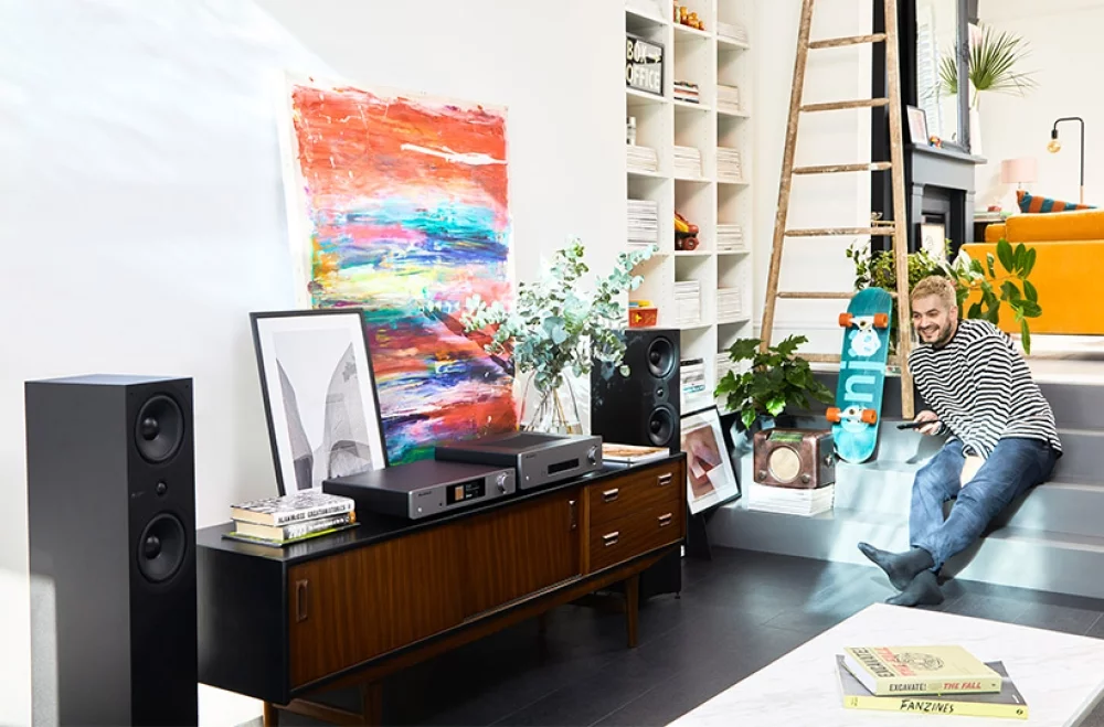 Man enjoying CXA61 setup in living room