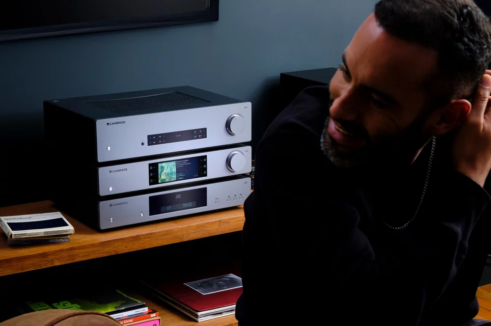 Young man enjoying the sound of a CX range stack, including the CXN100 Network Player